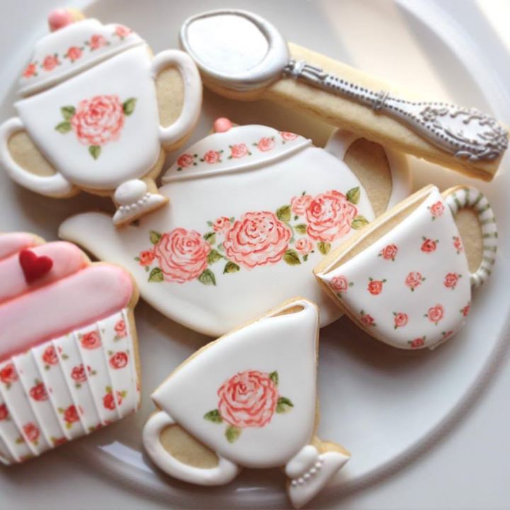 Elegant Tea-Themed Cookies with Intricate Rose Patterns for Whimsical Dessert Displays.