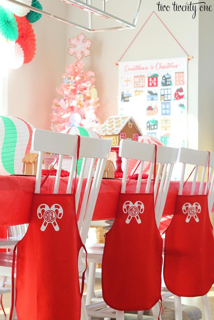 Cheerful Festive Dining Setup with Red Aprons and Vibrant Decorations for Holiday Gatherings.