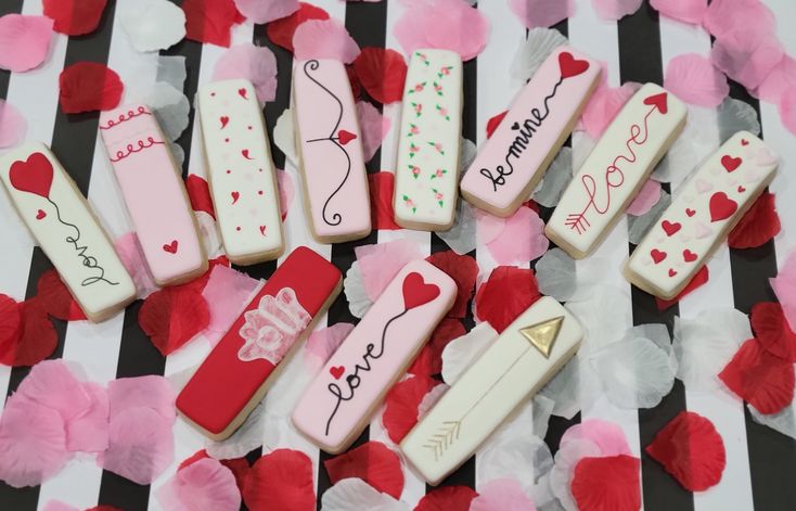 Valentine's Day-Inspired Decorative Nail Designs: Whimsical Hearts and Playful Patterns in Pink and White.