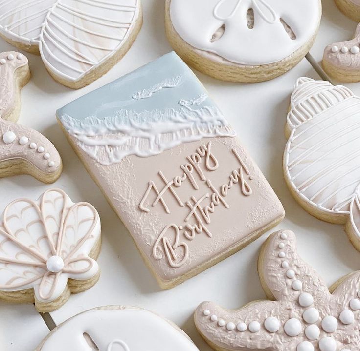 Coastal-Inspired Elegant Cookies: Serene Celebration Treats in Soft Beachy Hues.