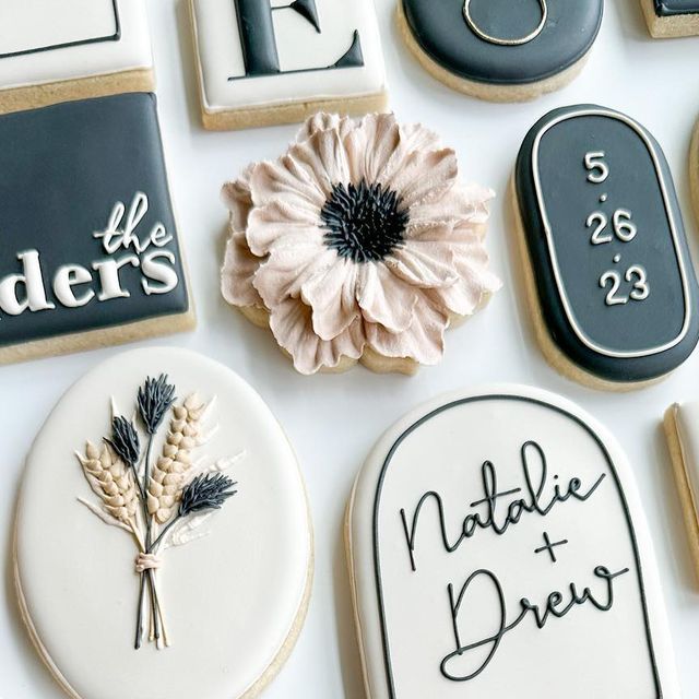 Charming Elegant Cookies: Soft Pastels with Bold Black Accents and Intricate Floral Designs.