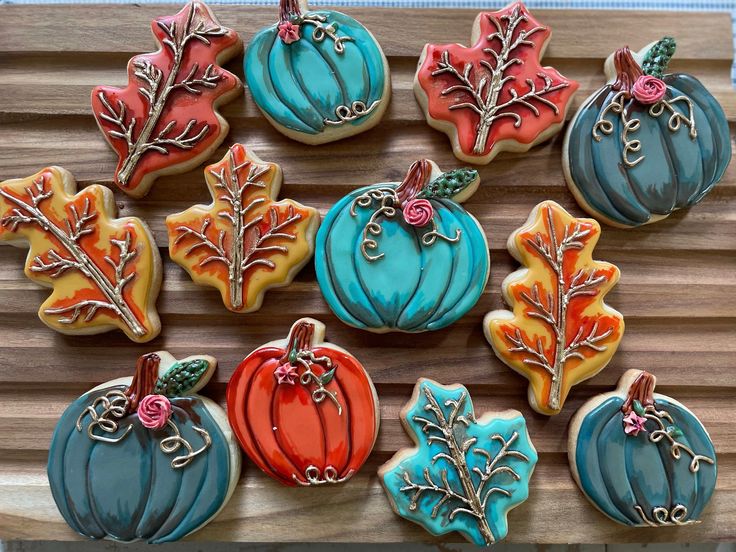 Elegant Autumn Cookies with Pumpkin and Leaf Designs in Vibrant Colors.