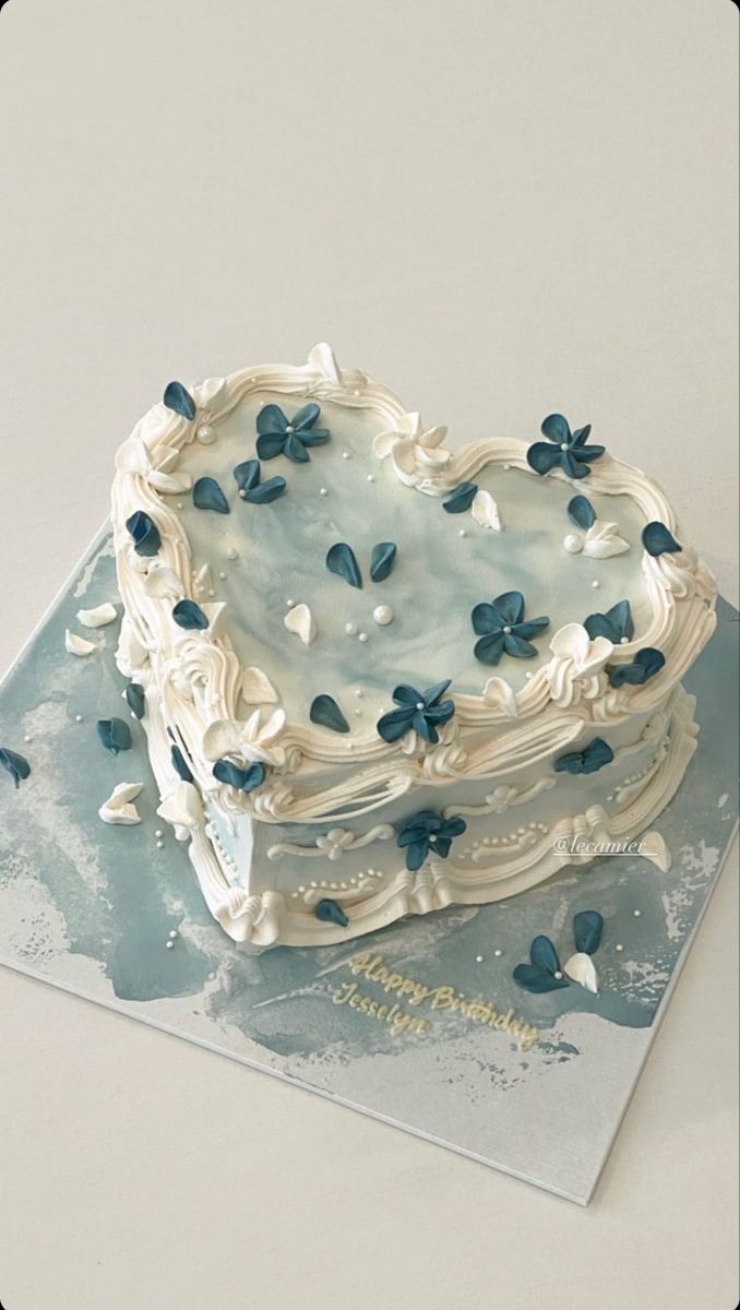 Elegant Heart-Shaped Cake with Delicate Blue Flowers: A Serene Delight for Special Celebrations.