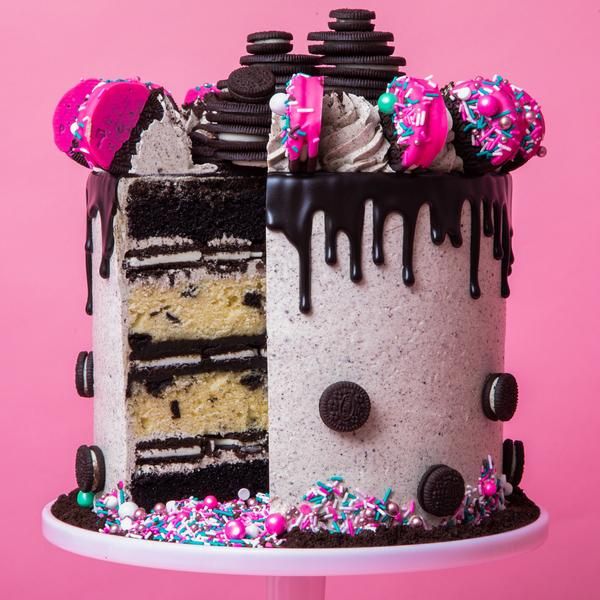 Whimsical Layered Chocolate-Vanilla Cake Topped with Pink Frosting and Colorful Sprinkles for Festive Celebrations