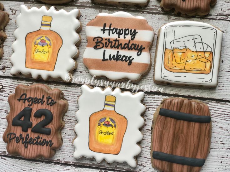 Whiskey-Themed Decorative Cookies with Vibrant Illustrations and Rustic Elegance.