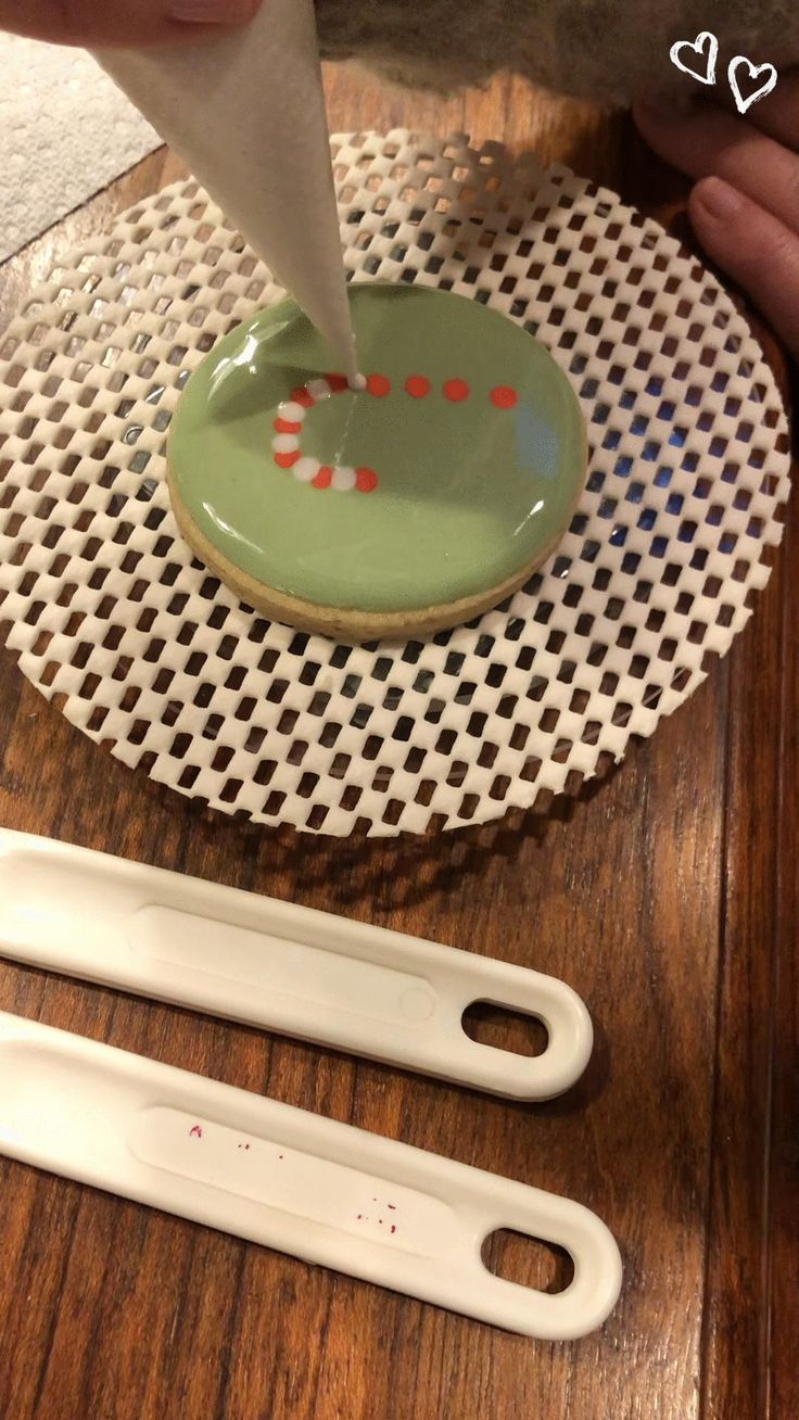 Festive Green Cookie Design with Candy Cane Patterns and Intricate Piping.