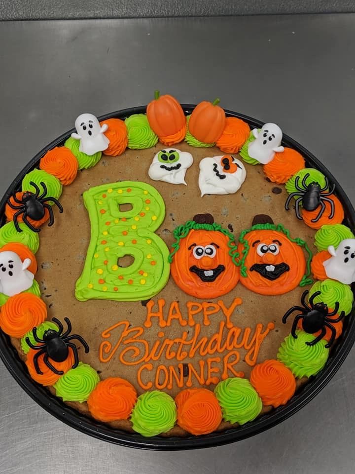 Festive Halloween-Themed Colorful Birthday Cake Design with Playful Pumpkin and Ghost Decorations.