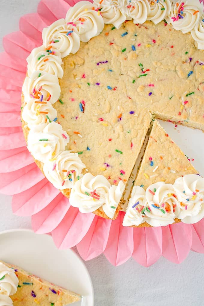 Festive Colorful Cookie Cake with Creamy Frosting and Whimsical Design.