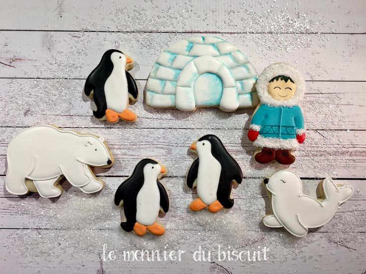 Whimsical Winter Cookies: Adorable Penguins, Seal, and Polar Bear Create a Playful Scene for Celebrations.