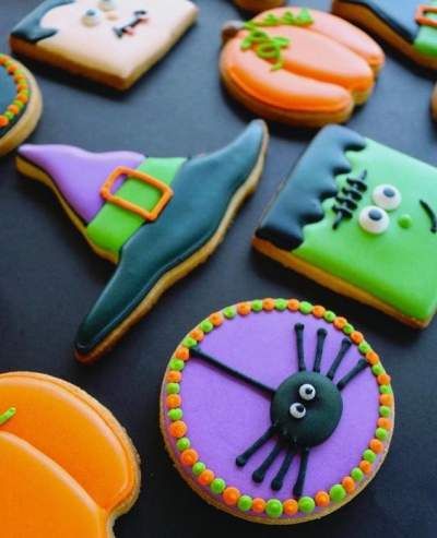 Playful Display of Colorful Halloween-Themed Cookies: Whimsical Designs Inspire Creative Nail Art