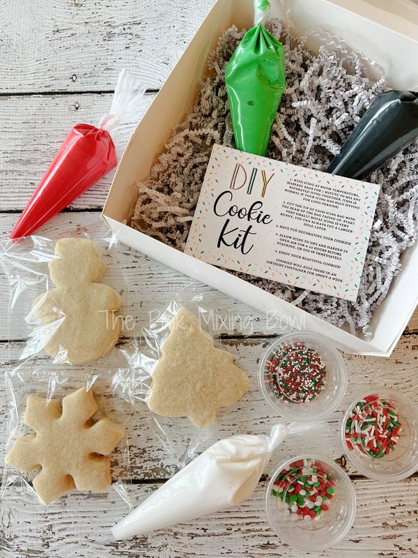 Festive DIY Cookie Kit with Colorful Icing, Cutouts, and Sprinkles for Holiday Fun.