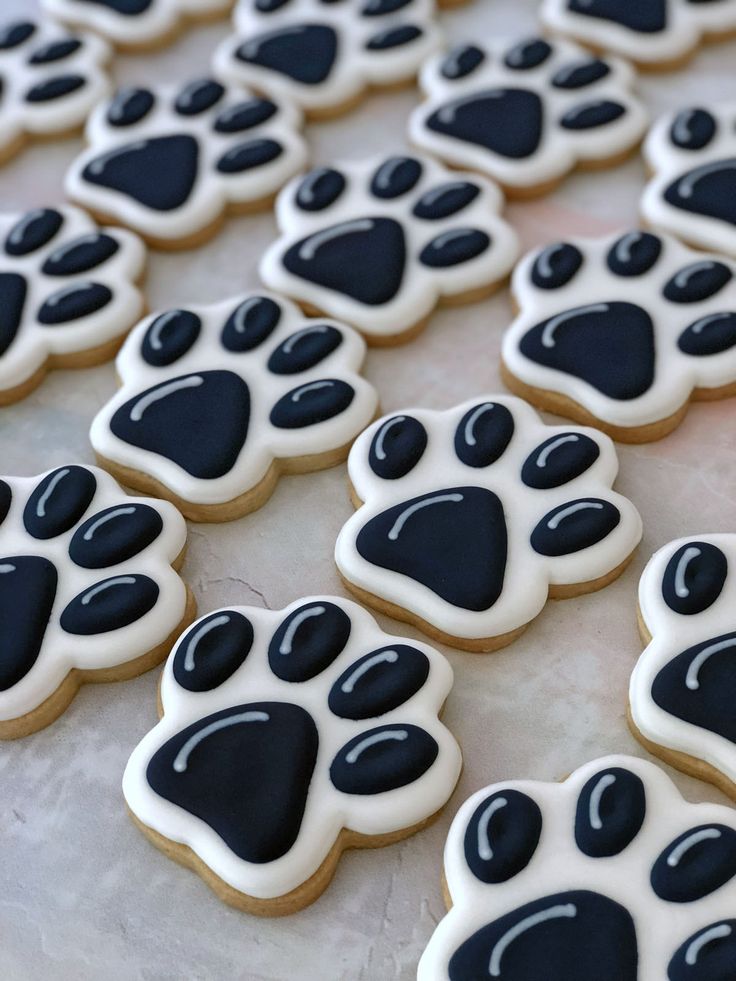 Playful Paw Print Cookies: Bold Black and White Design for Pet Lovers.