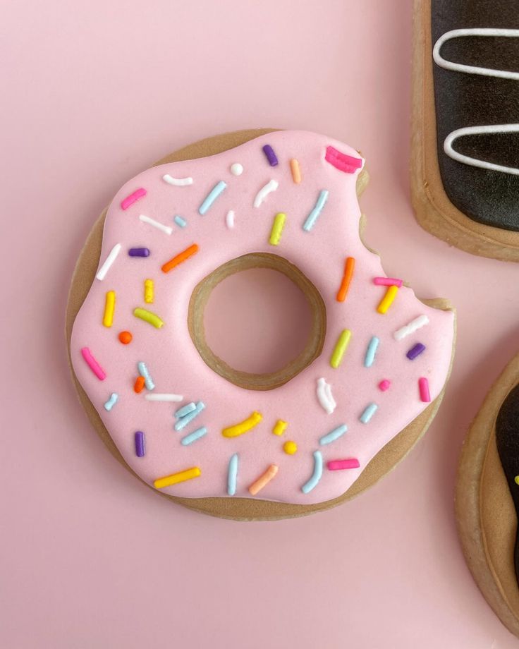 Playful Pastel Pink Donut-Inspired Nail Design with Vibrant Sprinkles.