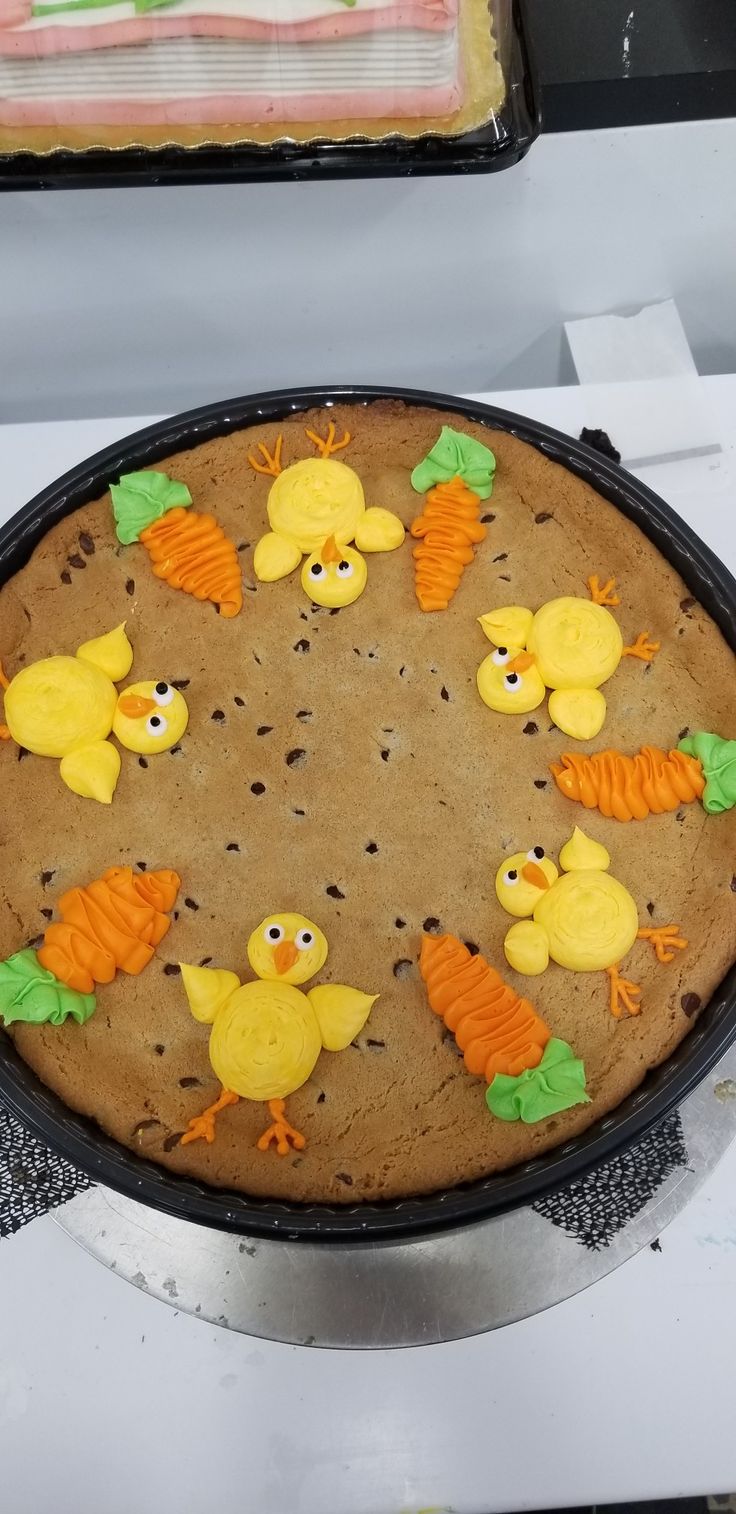 Whimsical Springtime Cookie Cake Decorated with Cute Chicks and Carrots in Vibrant Colors.