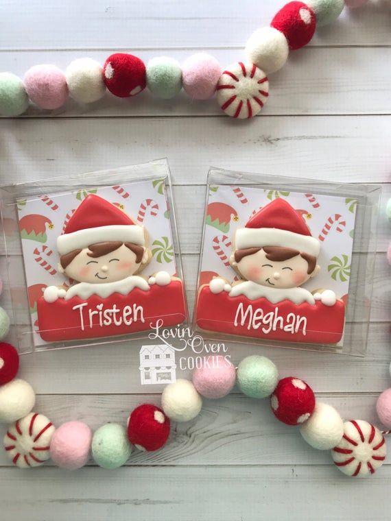 Cheerful Festive Cookie Designs Showcasing Holiday Characters in Red and White with Colorful Felt Ball Garland.