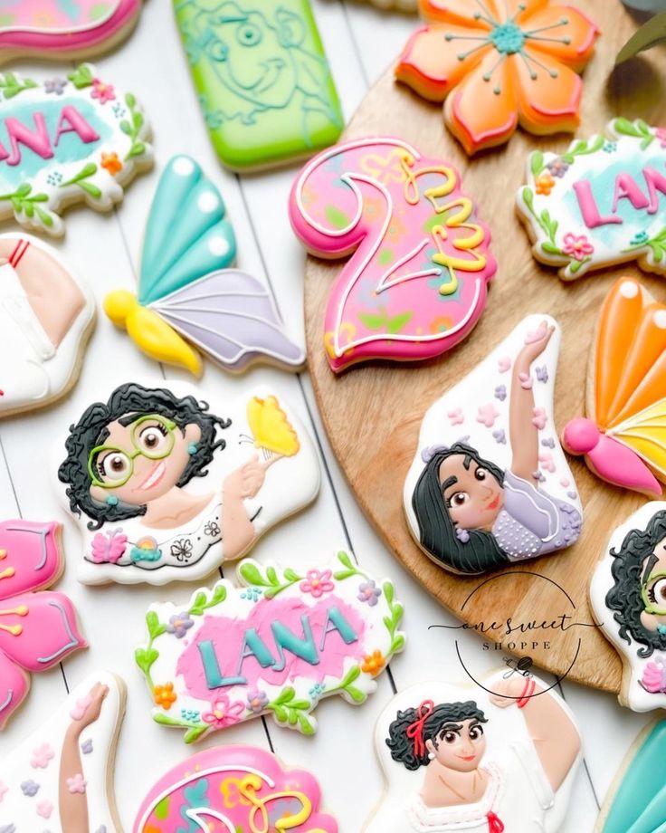 Vibrantly Themed Decorated Cookies with Floral, Butterfly, and Character Designs.