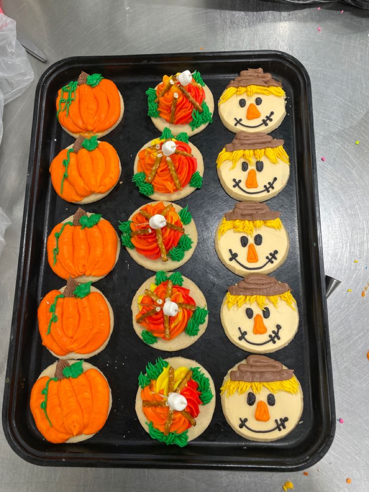 Festive Fall-Themed Pumpkin Cookies with Vibrant Icing and Cheerful Scarecrow Designs