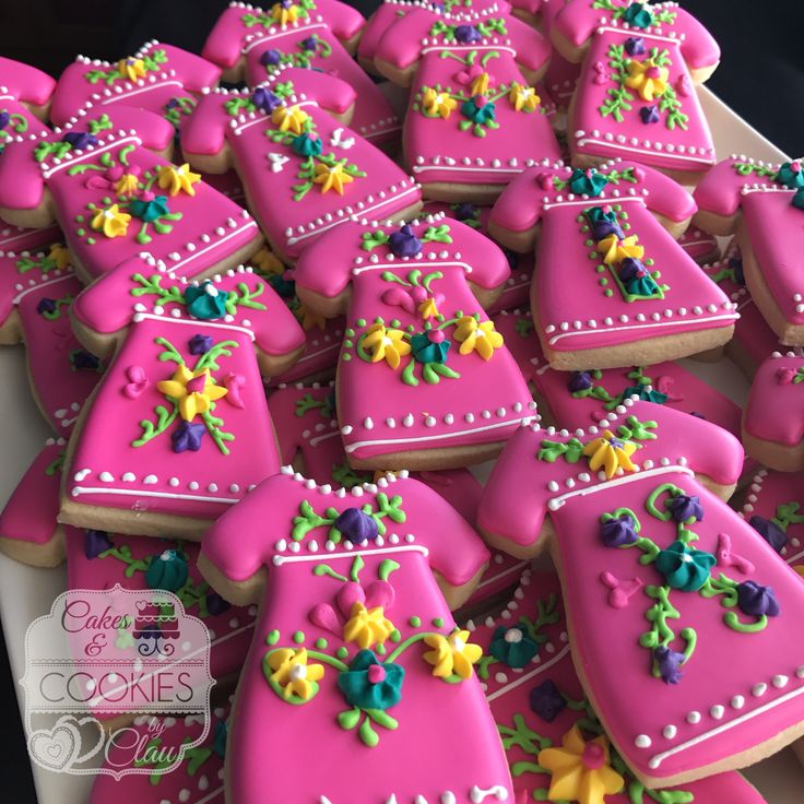 Vibrant Floral Cookies: Playful Pink Bases with Intricate Yellow and Green Icing Designs