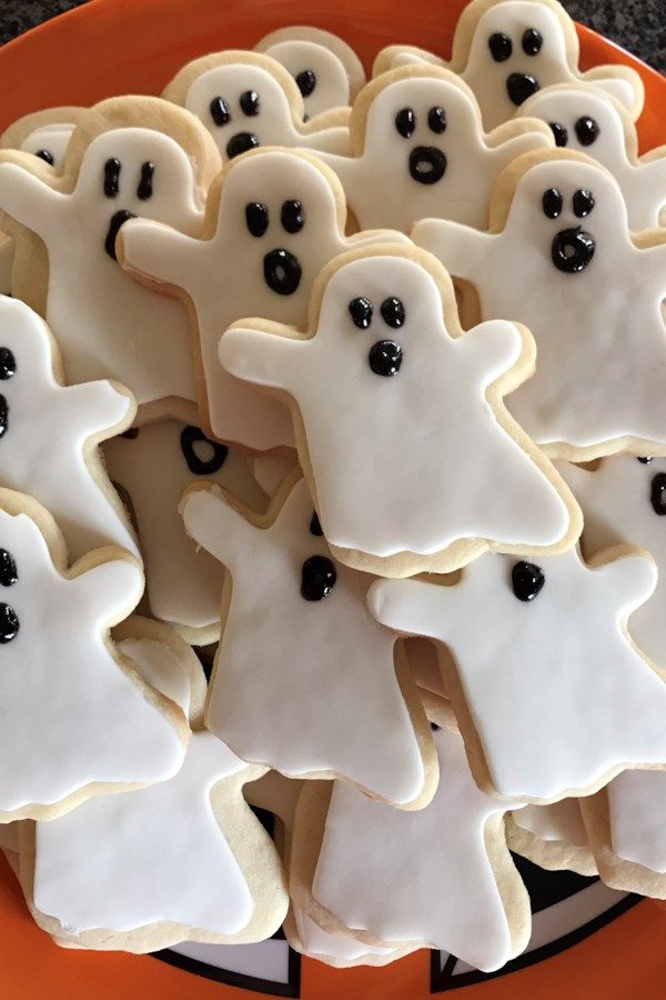 Whimsical Ghost-Shaped Cookies with Glossy Icing for Festive Halloween Treats.