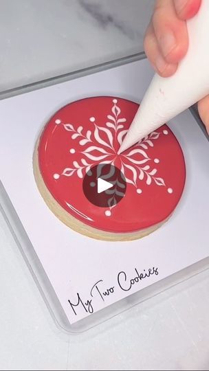 Artistry of Snowflake-Inspired Cookie Decoration on a Vibrant Red Background.