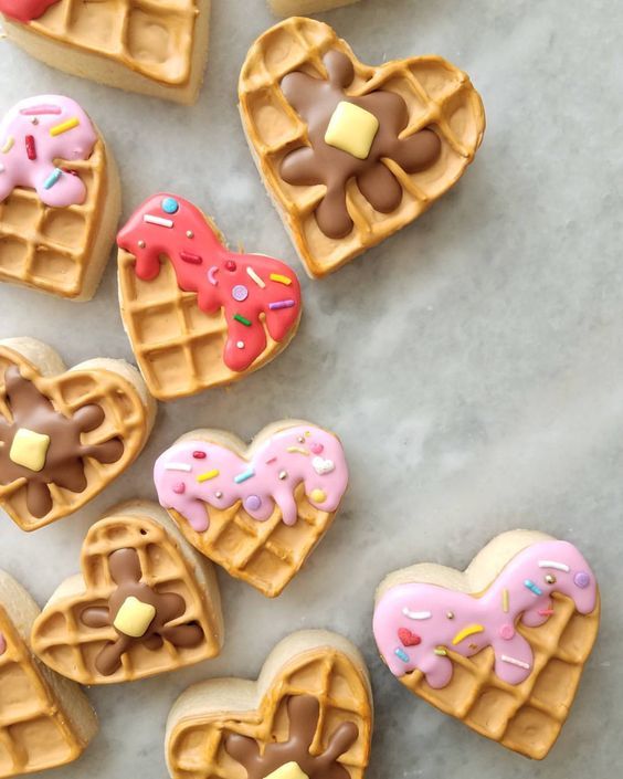 Whimsical Heart-Shaped Waffle Cookies with Colorful Icing and Playful Sprinkles.