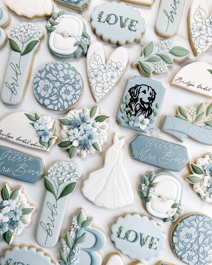 Charming Wedding-Themed Cookies in Soft Blue and White with Intricate Floral Designs.