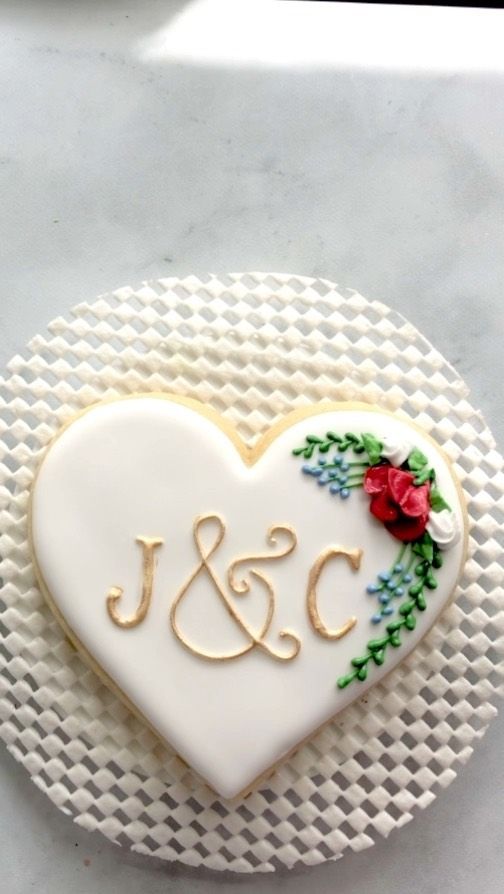 Charming Heart-Shaped Cookie Adorned with Intricate Floral Icing Design