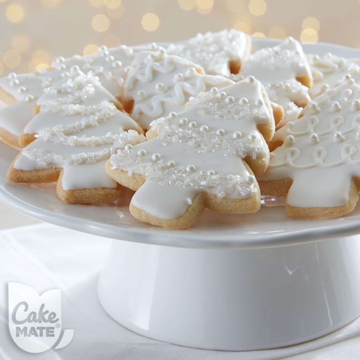 Elegant Christmas Tree Cookies: Intricately Iced Delights on a Pristine Pedestal.