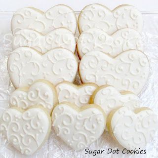 Elegant Heart-Shaped Cookies with Intricate Icing: The Perfect Centerpiece for Celebrations.