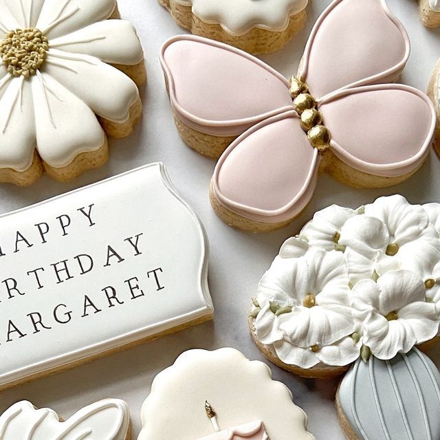 Whimsical Floral and Butterfly Cookies in Delicate Pastel Shades for Celebrations.