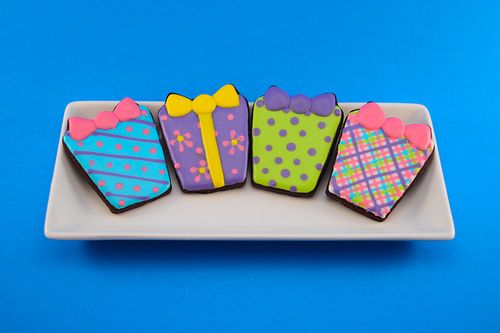 Vibrantly Designed Gift-Themed Cookies with Festive Patterns and Bow Accents.