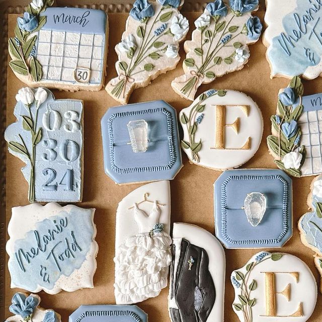 Elegant Floral-Themed Cookies with Blue and White Embellishments for Special Occasions.