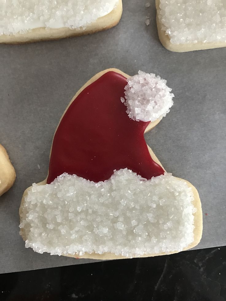 Whimsical Santa Hat Cookie Design Adorned with Festive Icing and Sparkling Sugar Crystals.