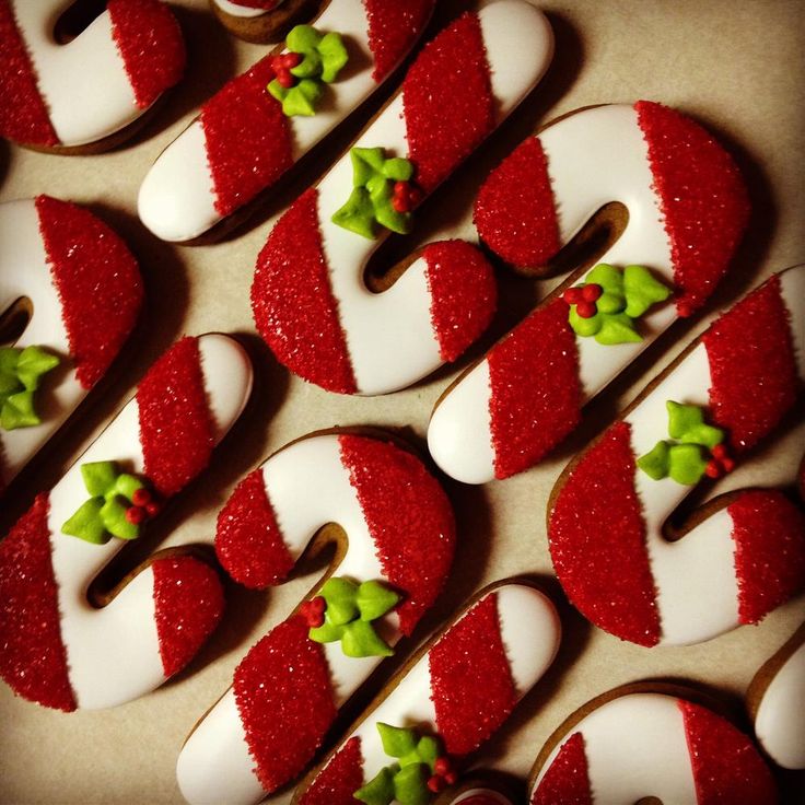 Festive Candy Cane Cookies with Vibrant Red and White Stripes and Holly Accents