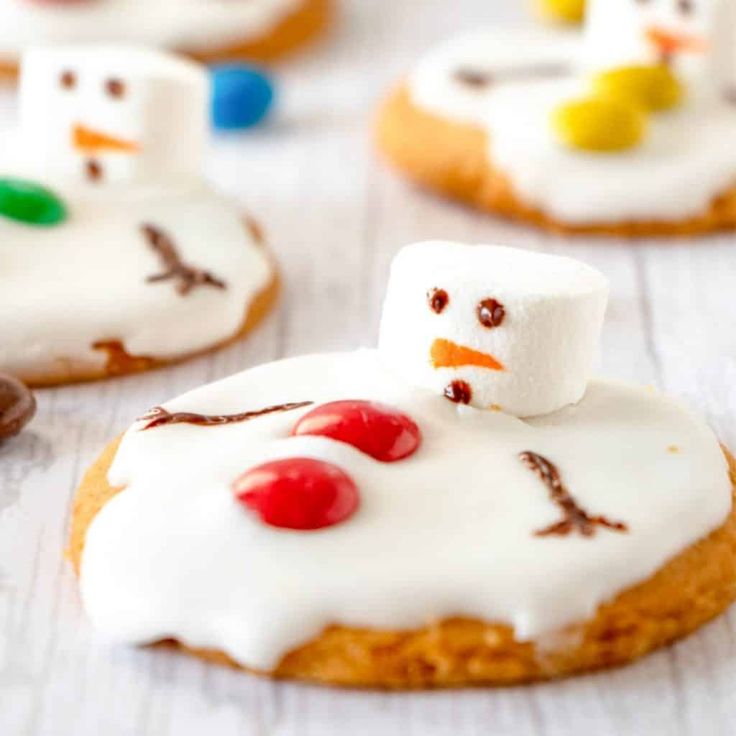 Festive Snowman Cookies: Whimsical Winter Treats Topped with Marshmallows and Candies.