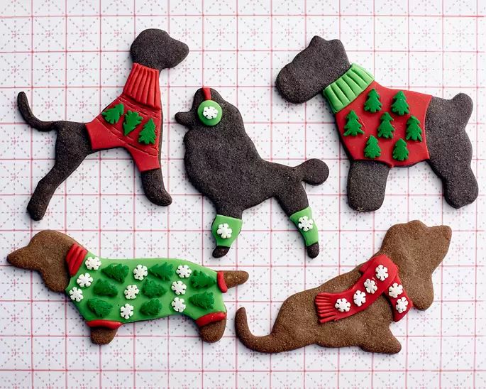 Adorable Holiday Dog-Shaped Cookies Adorned with Colorful Sweaters and Icing