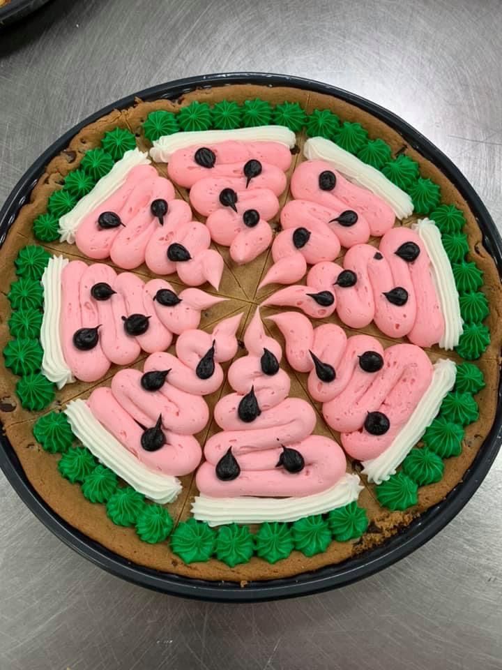 Watermelon-Inspired Colorful Cake with Pink Icing Swirls and Chocolate Chip Seeds Perfect for Summer Celebrations.