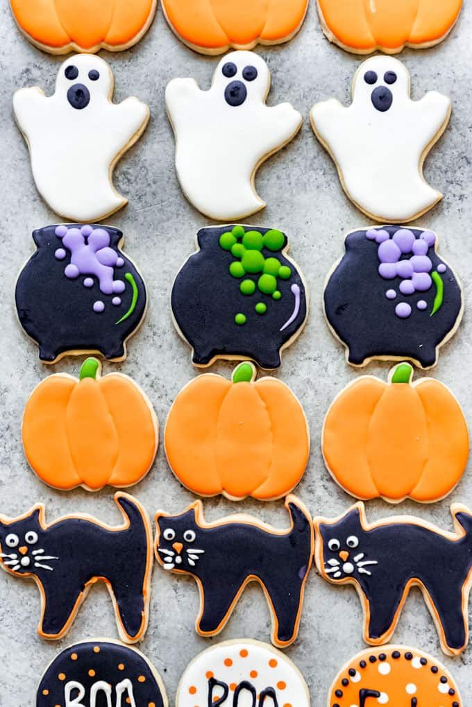 Festive Halloween Cookies Adorned with Ghosts, Pumpkins, and Black Cats for a Whimsical Celebration.