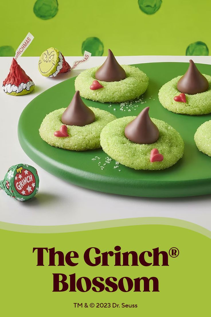 Whimsical Grinch-Inspired Holiday Cookies: Festive Green Base Adorned with Chocolate Kisses and Heart-Shaped Candies.