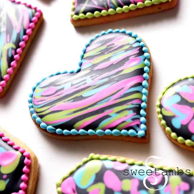 Vibrant Heart-Shaped Cookies with Intricate Piped Borders for Celebrations.