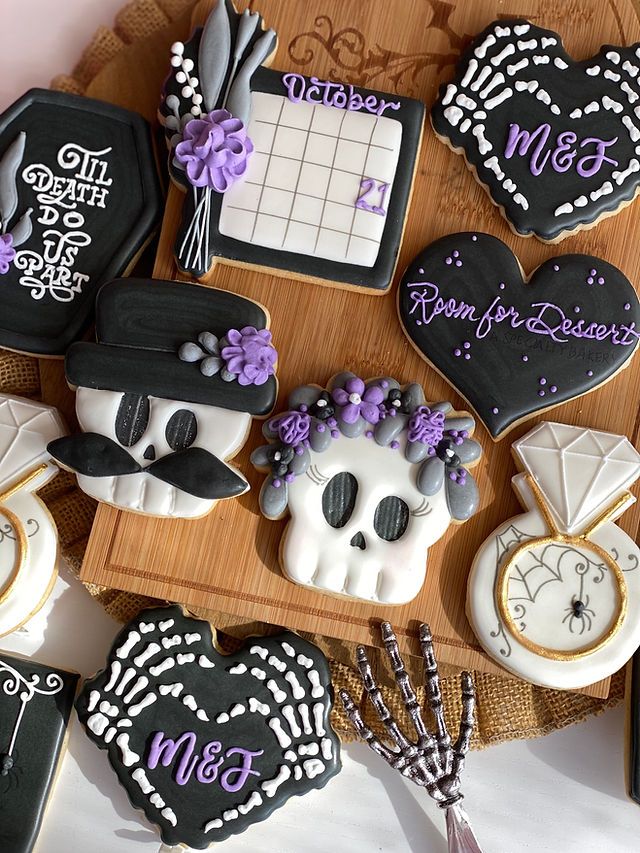 Gothic-Inspired Cookie Designs: Playful Skull Motifs and Floral Accents in Monochrome with Purple Highlights.