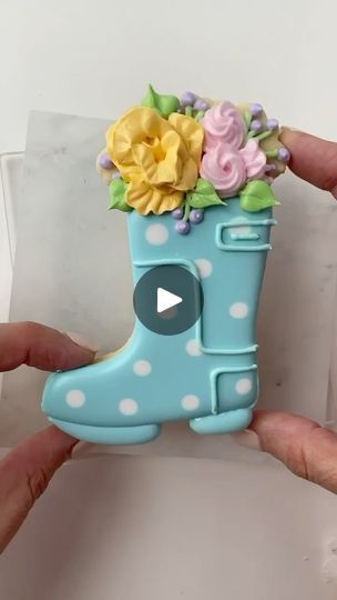 Whimsical Floral Boot Design: Playful Light Blue Base with Vibrant Spring Colors for Charming Nail Art.