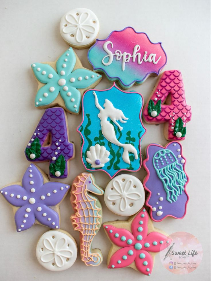 Whimsical Sea-Themed Sugar Cookies: Vibrant Starfish, Seahorses, and Mermaids for Celebratory Delights.