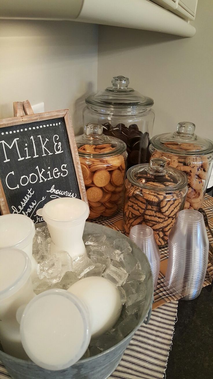 Charming Dessert Station: A Cozy Assortment of Cookies and Milk for Celebrations.