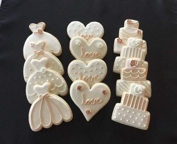 Romantic Wedding Cookies: Elegant Dress, Heart, and Cake Designs with Creamy Icing and Rose Accents.