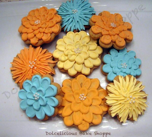 Vibrant Flower-Shaped Cookies with Intricate Piping and Elegant Pearls, Ideal for Spring Celebrations.