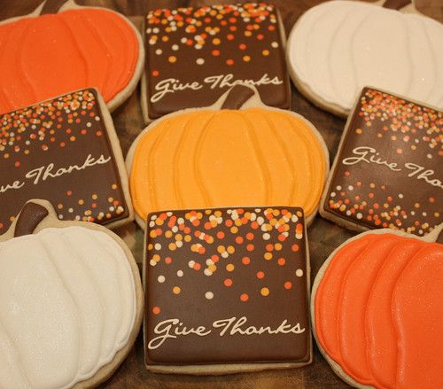 Vibrant Autumn-Themed Pumpkin Cookies with Glossy Icing and Festive Sprinkles.