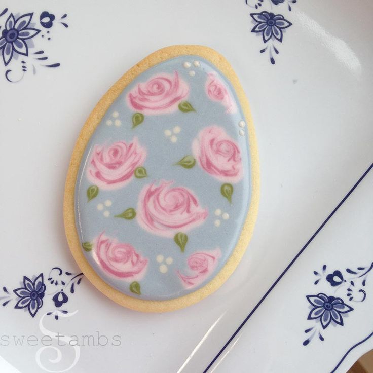 Pastel Pink Roses on Soft Blue: Elegant Floral Cookie Design Inspiring Nail Art Patterns.