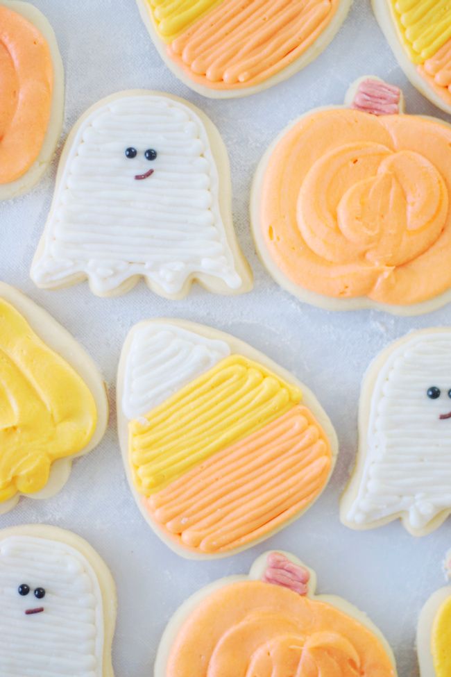 Whimsical Halloween Cookie Designs: Ghosts, Candy Corn, and Pumpkins Adorned with Vibrant Icing.