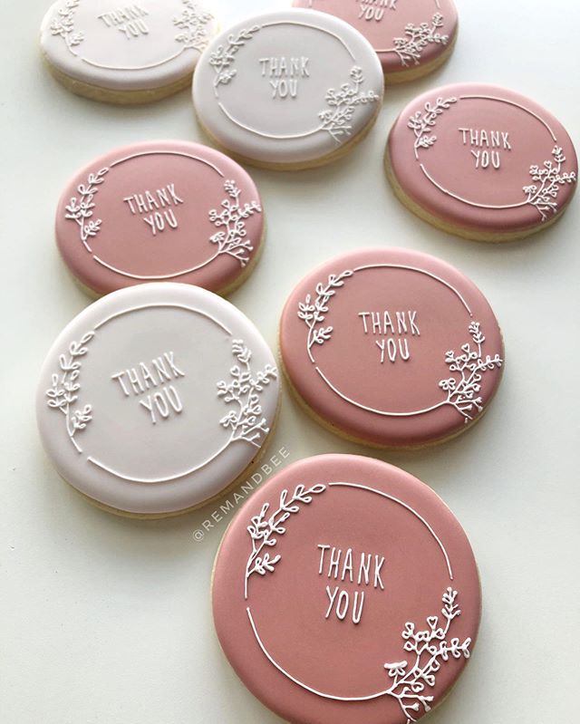 Elegant Floral-Piped Round Cookies: A Charming Blend of Soft Pink and White for Special Occasions.